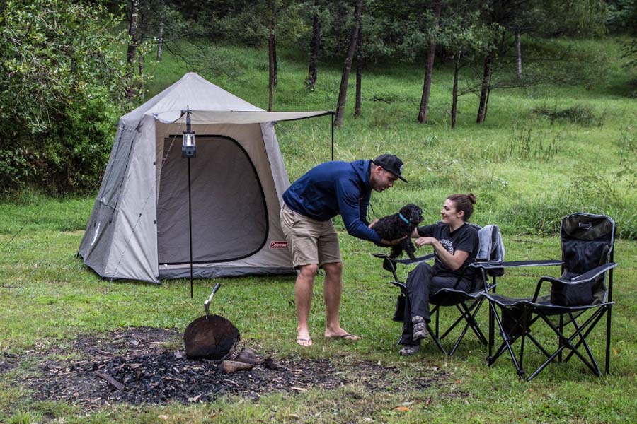 Couple with dog sitting near Instant Up 6p Tent