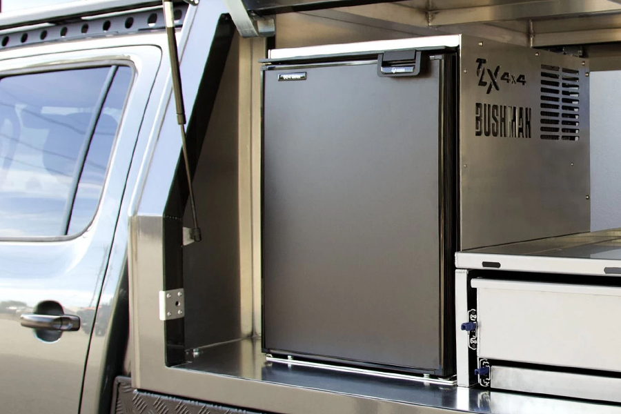 Ben and Lauren keep their cool on how to protect your 12V investment, consider integrated batteries, and exercise common sense A camping fridge in the back of a vehicle.
