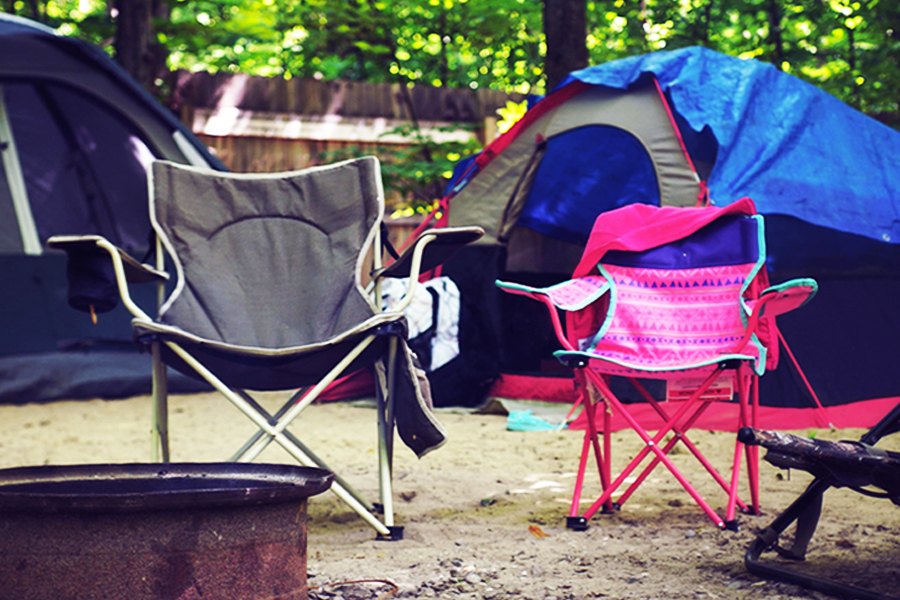 Tune in for an honest conversation about balancing access, affordability, and accountability in our cherished natural spaces A grey camp chair and a hot pink camp chair at a campsite, with a blue tent erect behind.