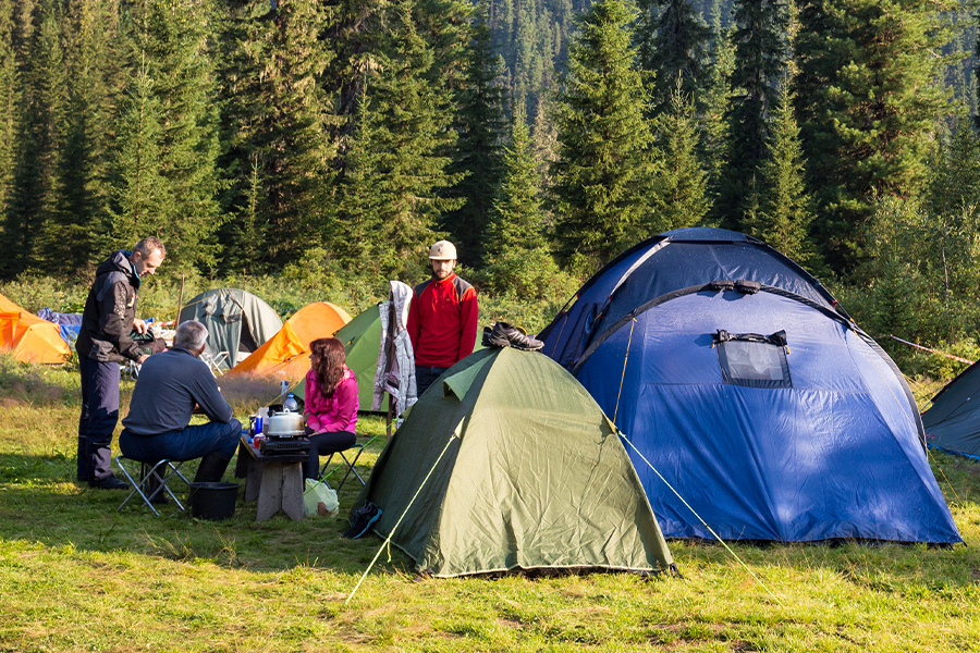 A go-getting, geared-up guide for anyone who's as ready to get out there as they are frozen at the front door! A group of campers surrounded by multiple colourful tents.