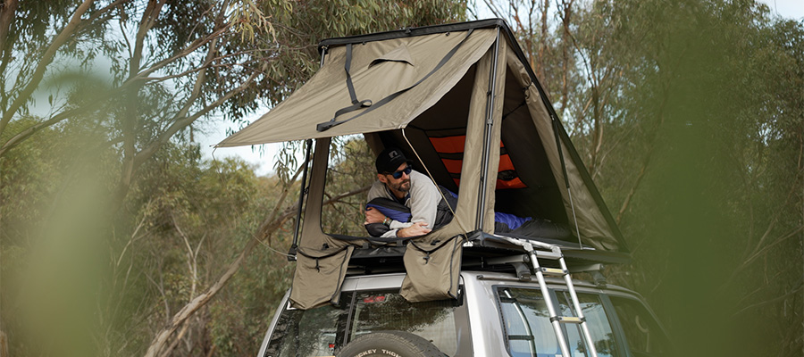 Image showing Ben from Snowys in an Inspired Overland rooftop tent on top of a Nissan GU Patrol